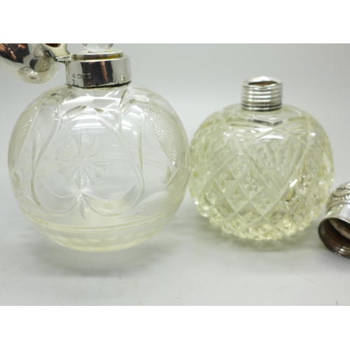 884 - Two silver topped glass scent bottles, one by William Comyns