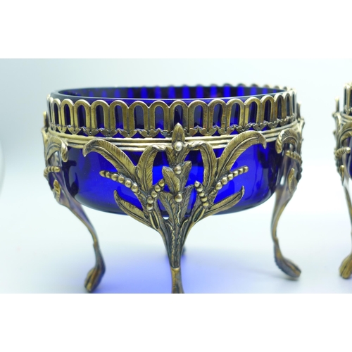 889 - A pair of Victorian silver oval table bon-bon dishes on four feet and with blue glass liners, London... 