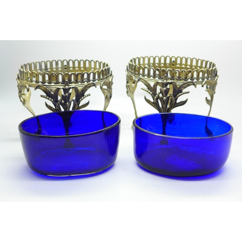 889 - A pair of Victorian silver oval table bon-bon dishes on four feet and with blue glass liners, London... 