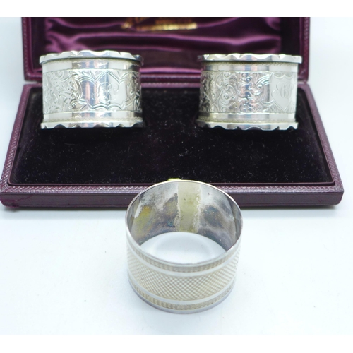 909 - A pair of silver napkin rings and one other silver napkin ring, 67g