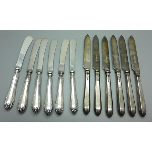 910 - Two sets of six silver handled knives