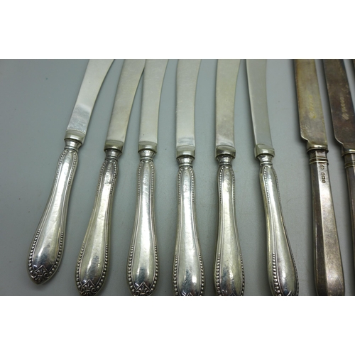 910 - Two sets of six silver handled knives