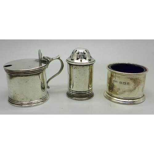 910B - A Victorian silver mustard and pepper, London 1885/6, and a silver salt, 111g