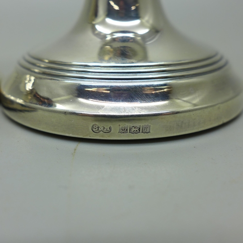 911 - A pair of silver dwarf candlesticks, weighted bases