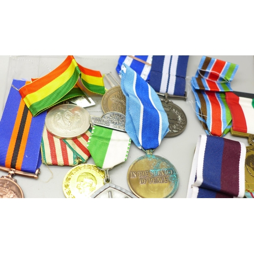 921 - A collection of medals including German, Soviet Union, cap badges and ribbons, (including some repro... 