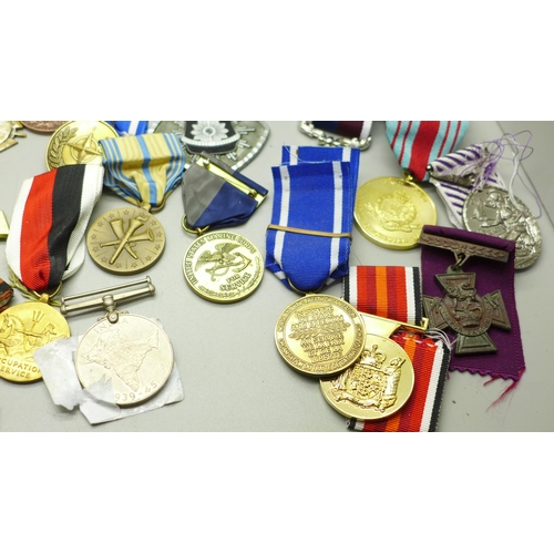 921 - A collection of medals including German, Soviet Union, cap badges and ribbons, (including some repro... 