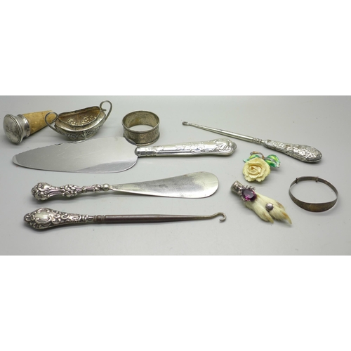 925 - A collection of silver and silver mounted items including silver handled implements, silver bangle, ... 