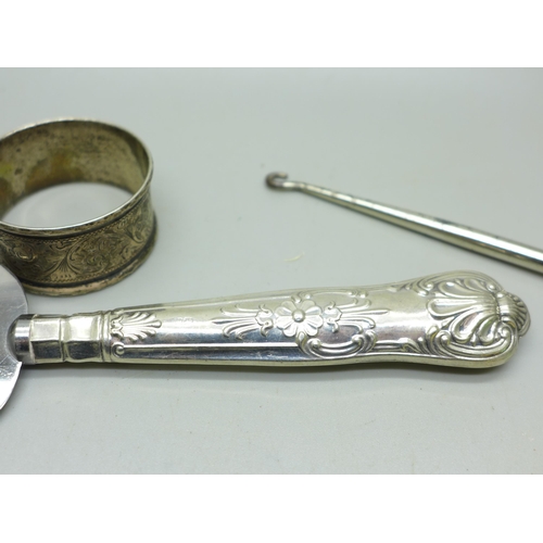 925 - A collection of silver and silver mounted items including silver handled implements, silver bangle, ... 