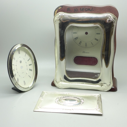 926 - A silver fronted clock case, (no movement), one other case and a plaque