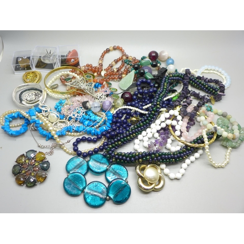 945 - A collection of bead necklaces and bracelets including semi-precious stones, etc.