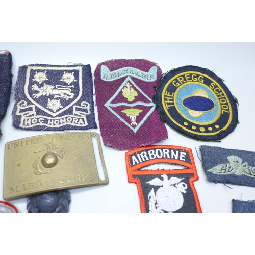 955 - Military badges, cloth badges and a US Marine Corps belt buckle