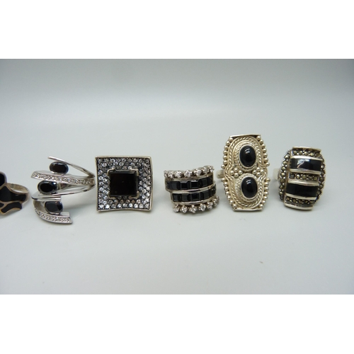 969 - Nine large chunky silver and white metal black stone set rings, mostly onyx, up to 32mm, 96g, six st... 