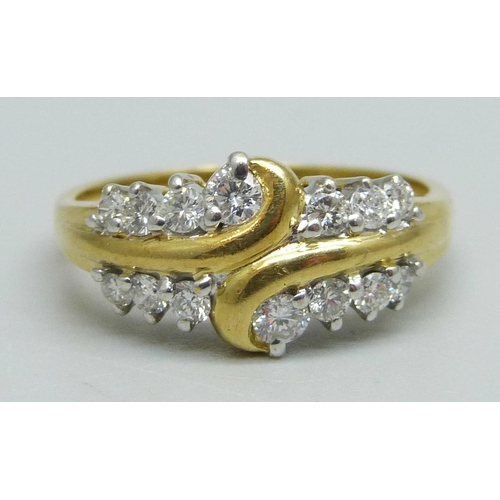 981 - An 18ct gold ring set with 14 diamonds, 4.4g, P/Q