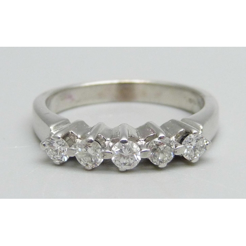 983 - An 18ct white gold ring set with five diamonds, 5g, O