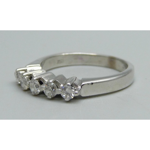 983 - An 18ct white gold ring set with five diamonds, 5g, O