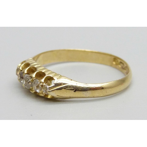 985 - An 18ct gold ring set with five diamonds, 2.1g, M