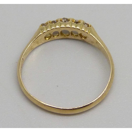 985 - An 18ct gold ring set with five diamonds, 2.1g, M