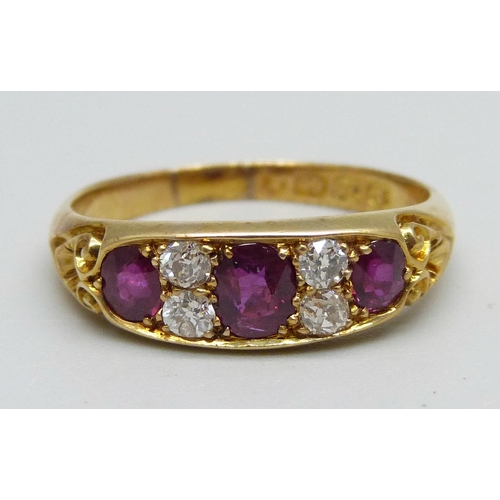 995 - A Victorian 18ct gold ring set with three rubies and four diamonds, 4.3g, S