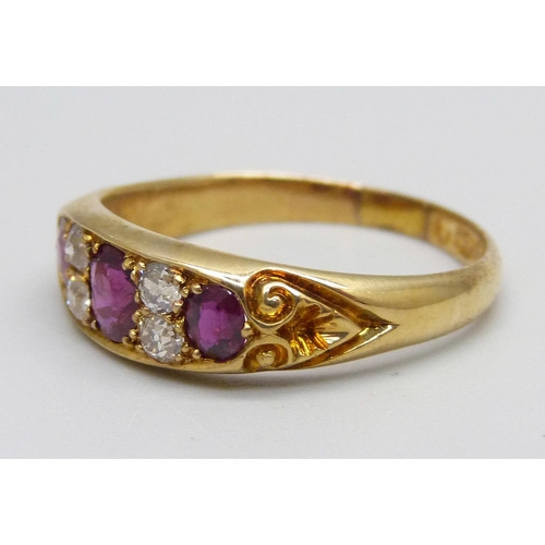 995 - A Victorian 18ct gold ring set with three rubies and four diamonds, 4.3g, S