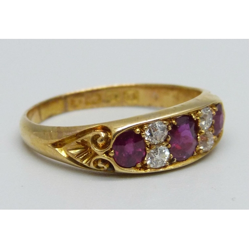 995 - A Victorian 18ct gold ring set with three rubies and four diamonds, 4.3g, S