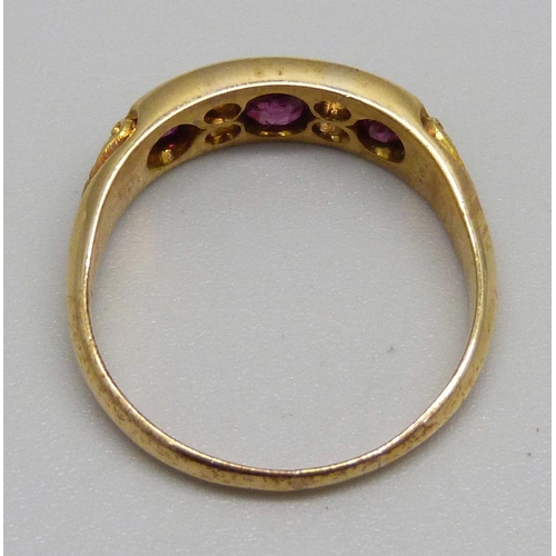 995 - A Victorian 18ct gold ring set with three rubies and four diamonds, 4.3g, S