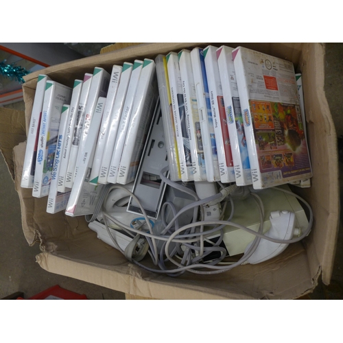 2070A - A Wii console and approx. 30 games including Mario and sonic at the Olympics, Fifa10, Rayman, Wii fi... 