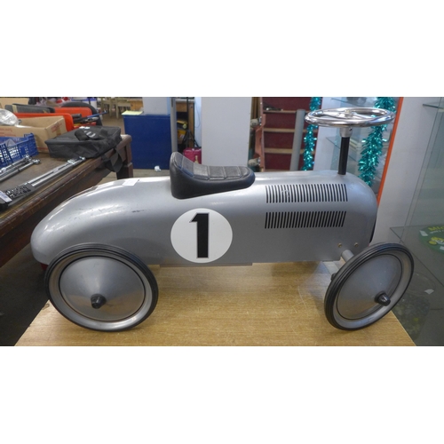 2093 - A silver Goki ride on metal race car