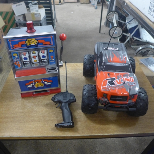 2343 - A remote controlled car with remote and Mega Million slot machine toy