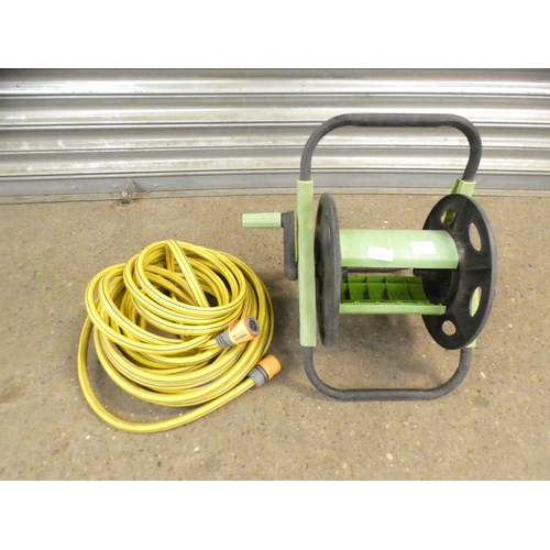 2223 - A hose reel and a length of Gardena hose pipe