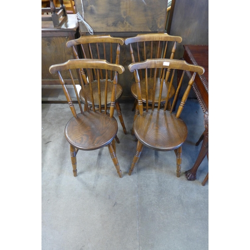 101 - A set of four Victorian elm and beech penny seat kitchen chairs