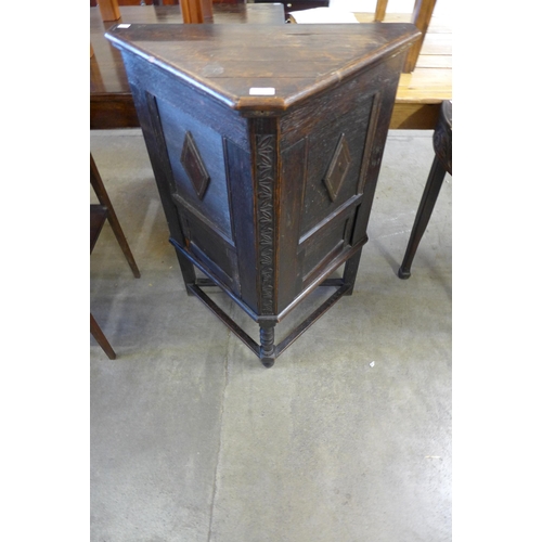 107 - An early 20th Century oak triangular cabinet