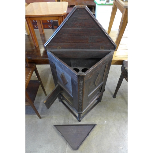 107 - An early 20th Century oak triangular cabinet