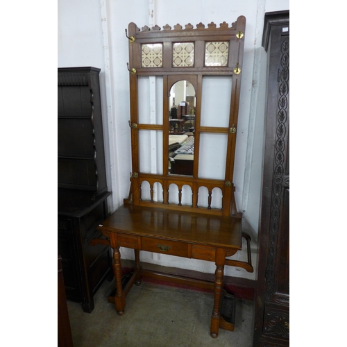 123 - A Victorian Aesthetic Movement oak and tiled back hallstand