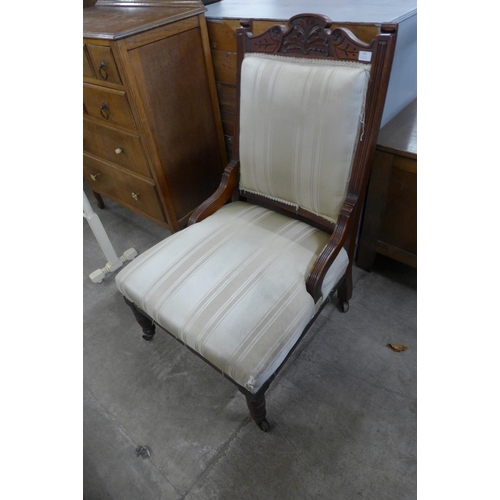 128 - A Victorian carved walnut and fabric upholstered armchair