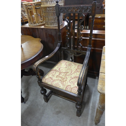 131 - A Victorian Jacobean Revival carved oak elbow chair