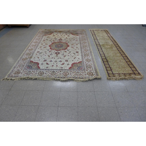 144 - Two beige ground rugs