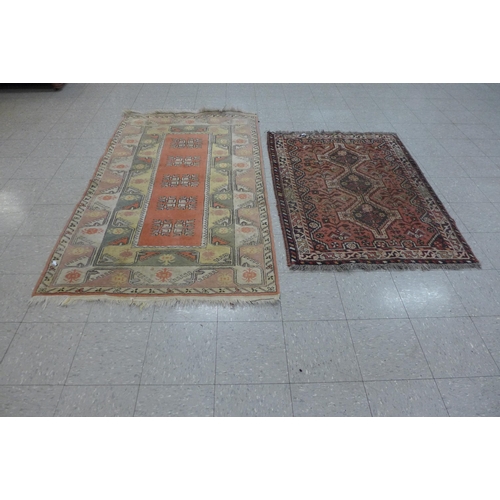 145 - A terracotta ground rug and one other