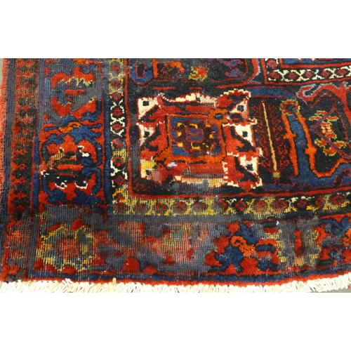 146 - An Iranian red ground rug, 395 x 325cms