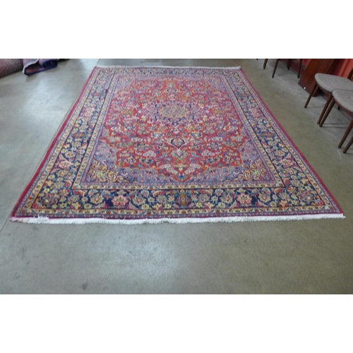 147 - An Iranian red ground rug, 332 x 253cms