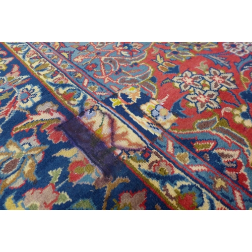 147 - An Iranian red ground rug, 332 x 253cms