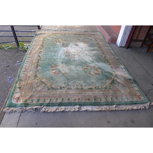 162 - A large Chinese green ground rug and one other