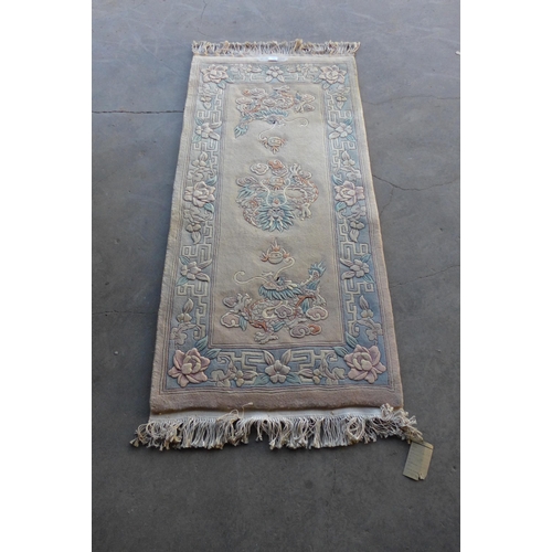 162 - A large Chinese green ground rug and one other