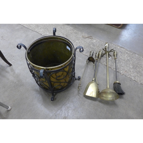 193 - A brass and wrought steel coal bucket and a companion set