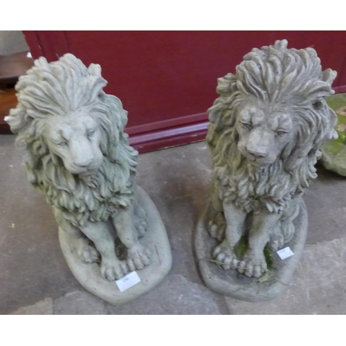 196 - A pair of concrete garden figures of seated lions