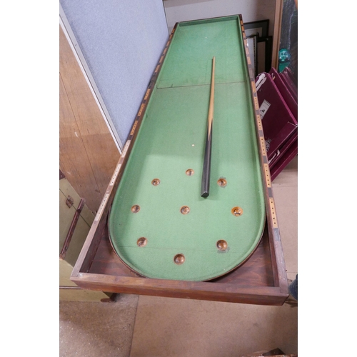 218 - A bagatelle board, games table and cue