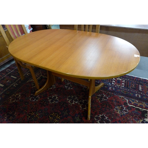 27 - A teak oval extending dining table and six chairs