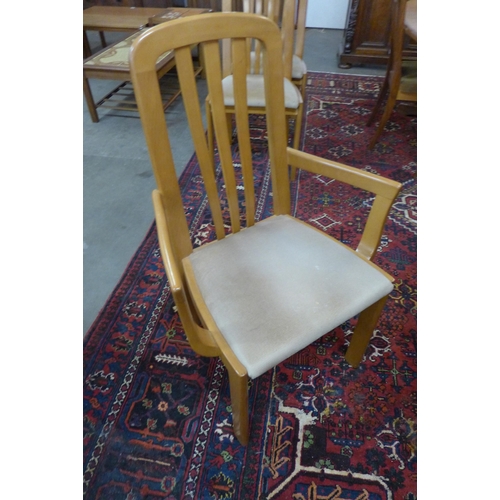 27 - A teak oval extending dining table and six chairs