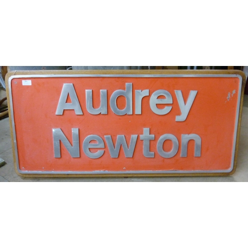 291 - A metal Audrey Newton sign