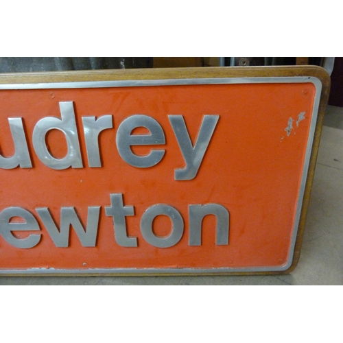 291 - A metal Audrey Newton sign