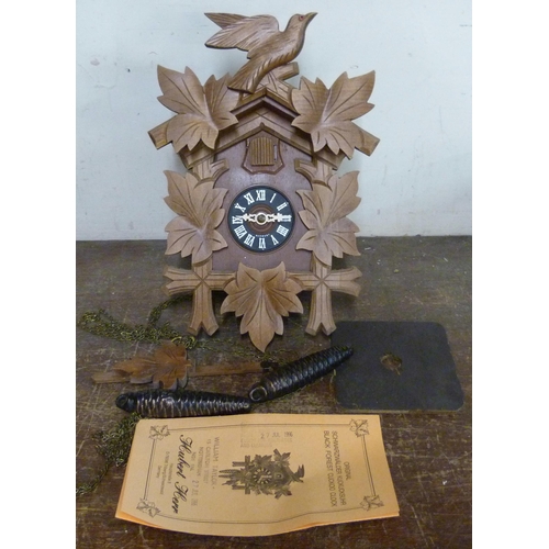 304 - A Black Forest beech and faux wood cuckoo clock